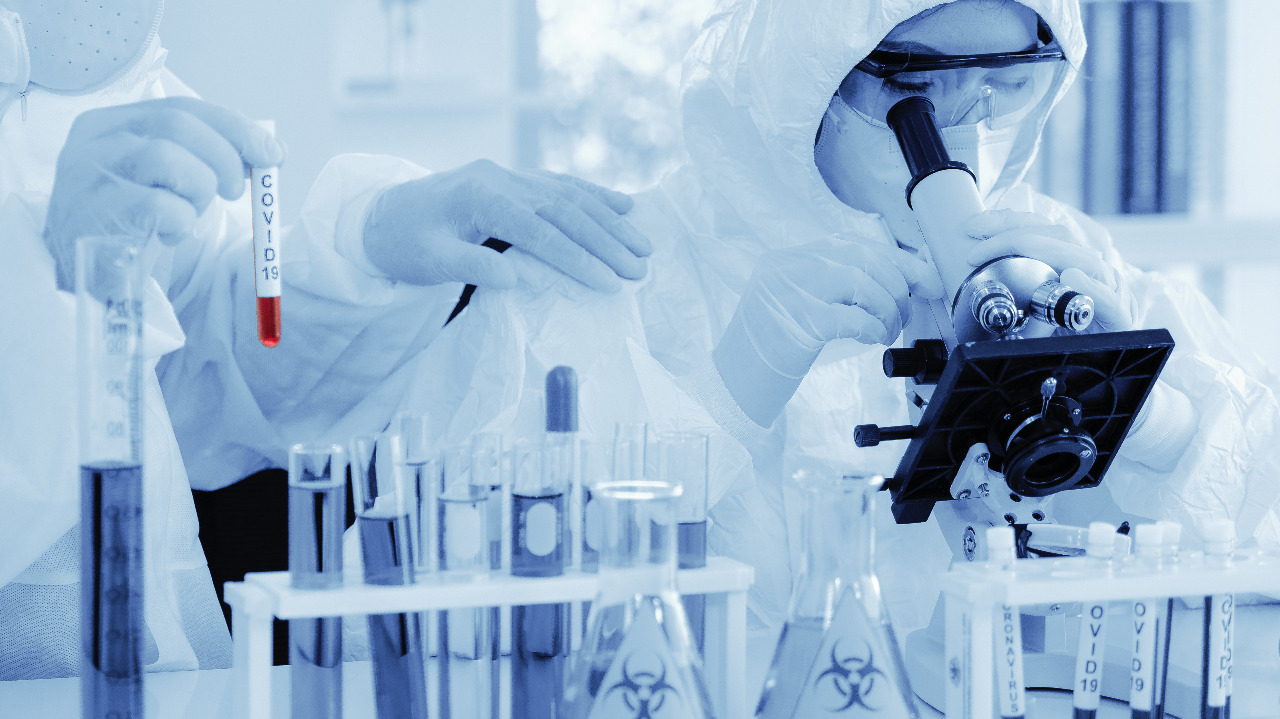 Scientists analyze COVID-19 samples. Image via Shutterstock. Scientists analyze COVID-19 samples. Image via Shutterstock.