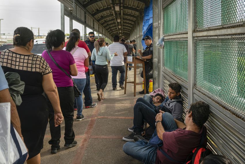 Asylum seekers from Central and South America wait on the Mexican side of the Brownsville/Gateway Bridge. Image by Reynaldo Leal. Mexico, 2019. Asylum seekers from Central and South America wait on the Mexican side of the Brownsville/Gateway Bridge. Image by Reynaldo Leal. Mexico, 2019.