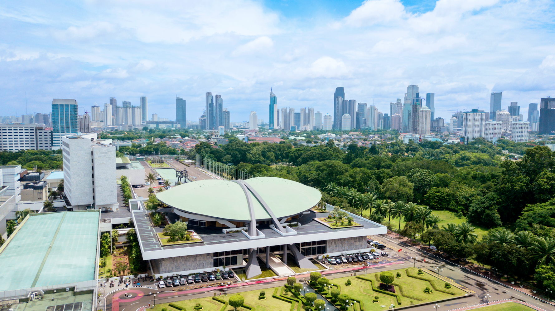 Aerial Image of the Indonesia Parliament Complex, also known as the DPR / MPR building, with Jakarta's cityscape at midday. Image by Creativa Images / Shutterstock. Indonesia, 2018. Aerial Image of the Indonesia Parliament Complex, also known as the DPR / MPR building, with Jakarta's cityscape at midday. Image by Creativa Images / Shutterstock. Indonesia, 2018.