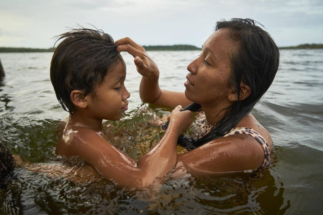 Tupí takes a bath with her 10-year-old son. Image by Pablo Albarenga. Brazil, 2019. Tupí takes a bath with her 10-year-old son. Image by Pablo Albarenga. Brazil, 2019.