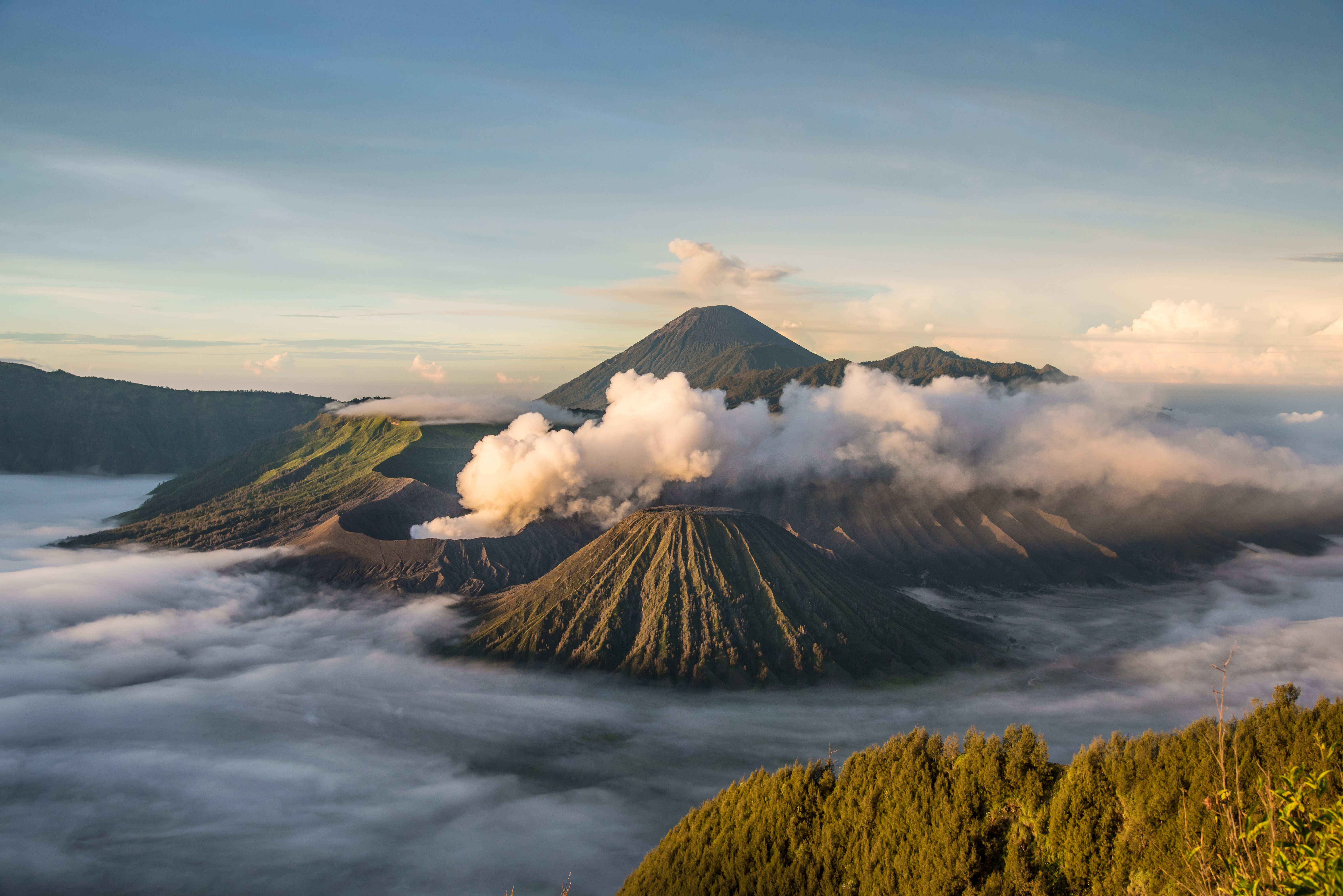 Mount Bromo with smoke, with Mount Batok in the foreground, and Mount Kursi and Mount Gunung Semeru in the background, volcano, in Bromo Tengger Semeru National Park. Image courtesy of Shutterstrock. Indonesia, date unknown. Mount Bromo with smoke, with Mount Batok in the foreground, and Mount Kursi and Mount Gunung Semeru in the background, volcano, in Bromo Tengger Semeru National Park. Image courtesy of Shutterstrock. Indonesia, date unknown.