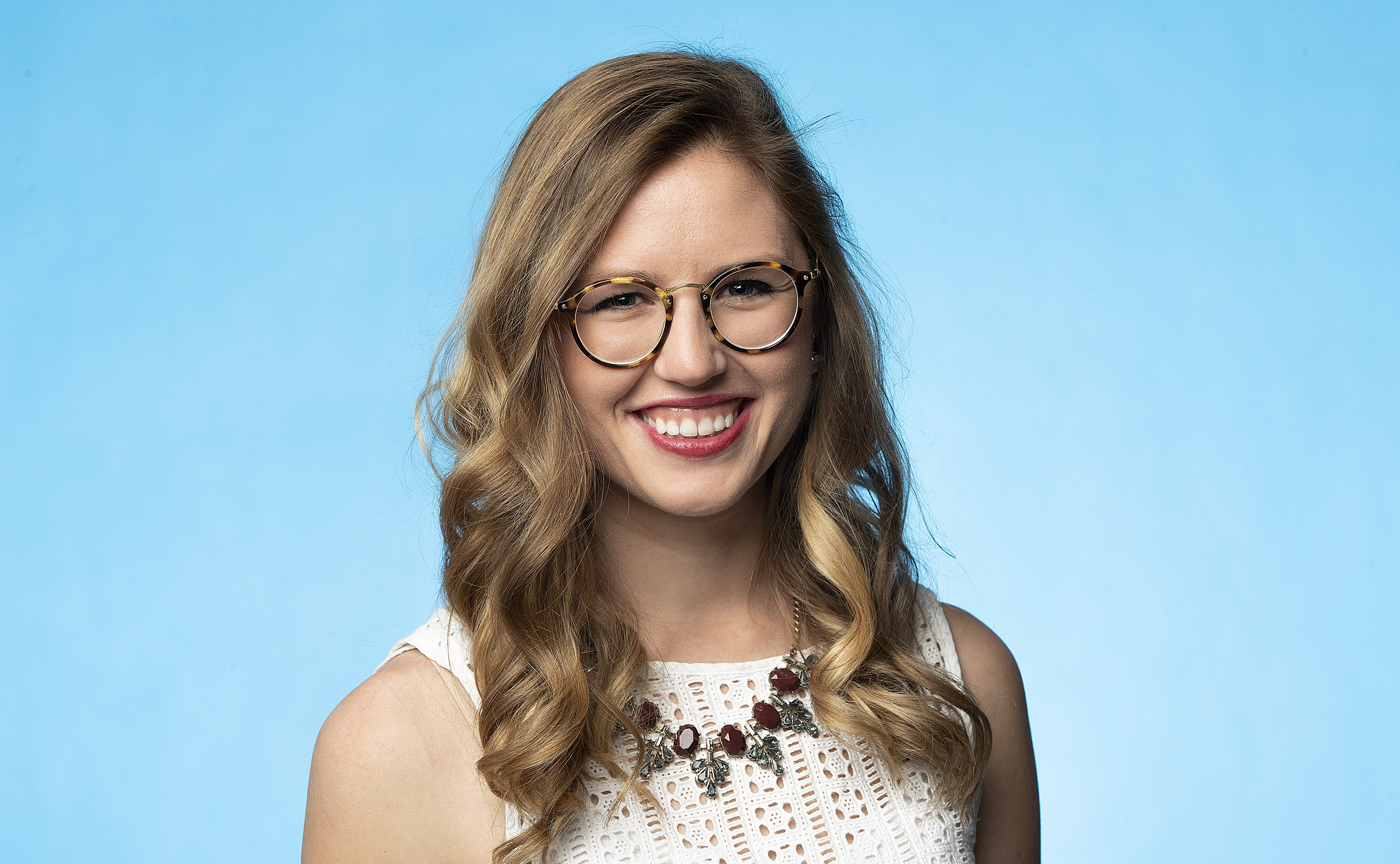 photo of emily in front of blue background