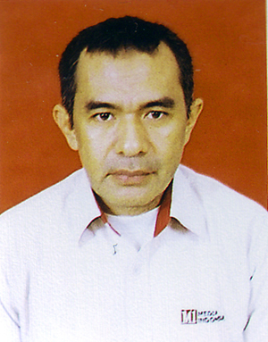 A person with short black hair and a white work shirt.