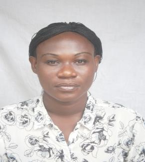 A woman wears a white floral-patterned shirt.