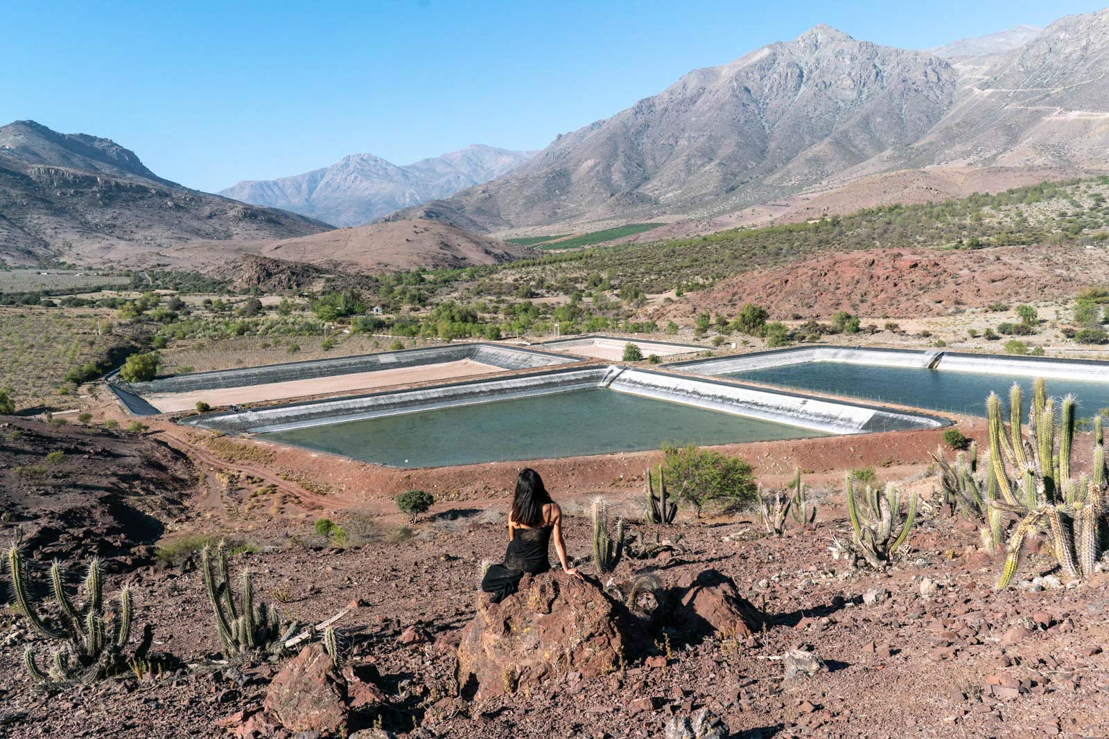 A person looks out on a reservoir