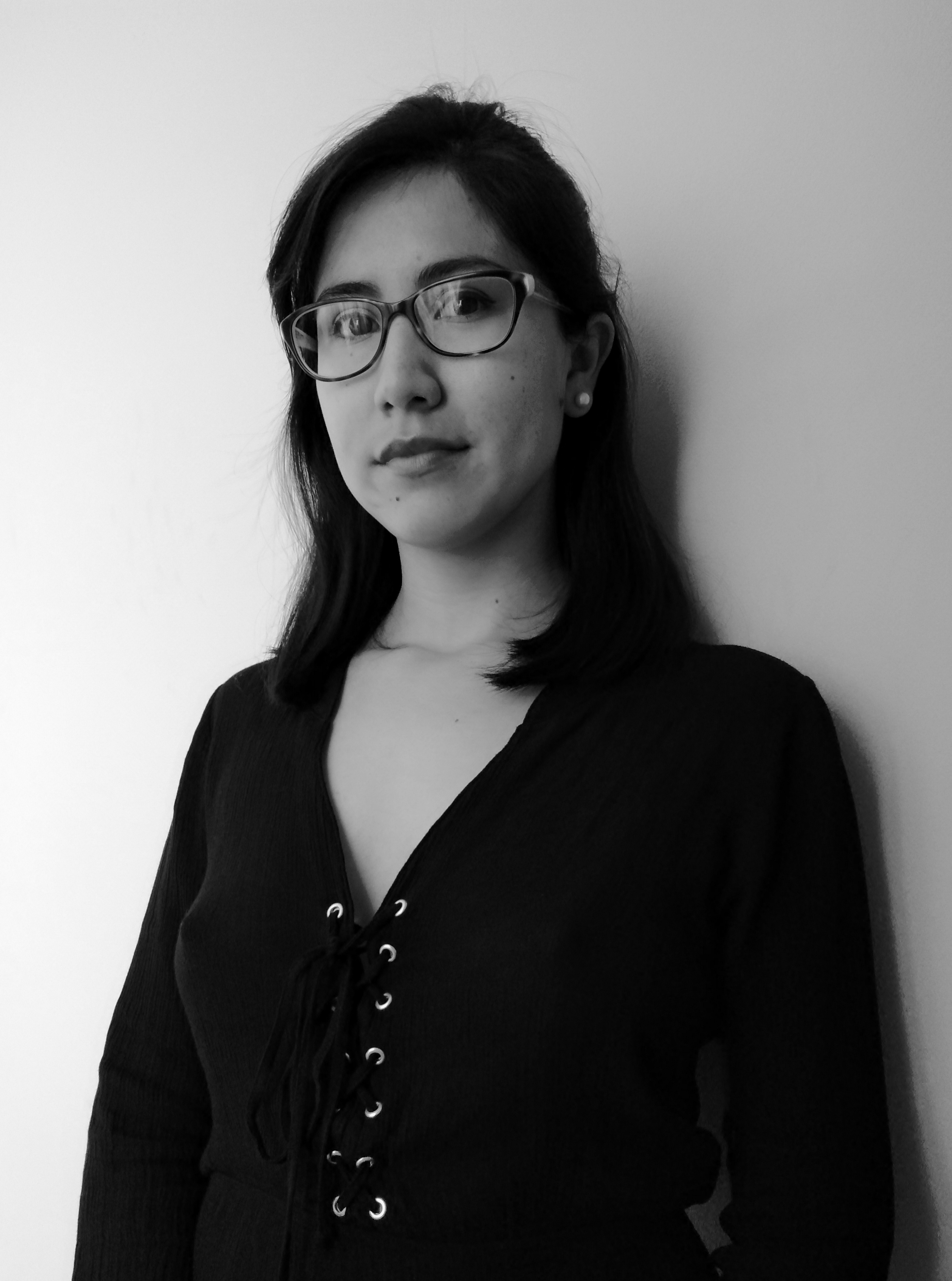 black and white headshot of a woman with long dark hair and glasses