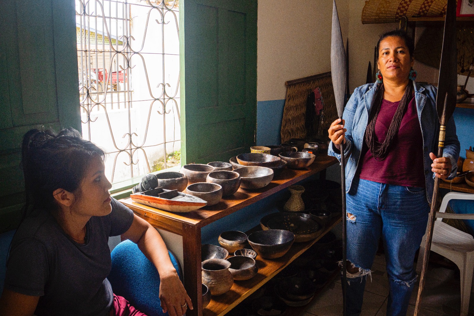 two people holding traditional tools