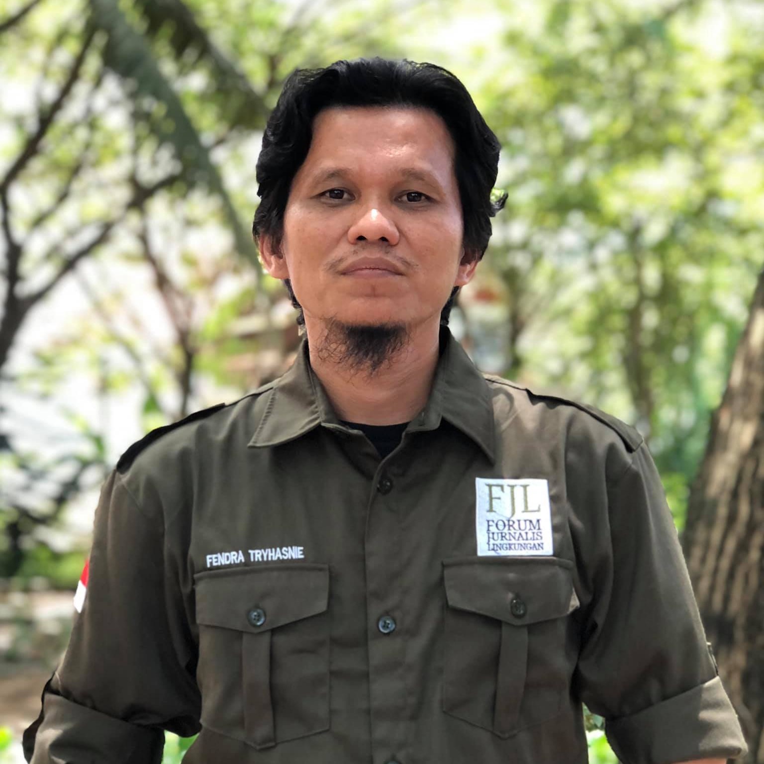 Fendra Tryshanie stands clad in military green shirt.