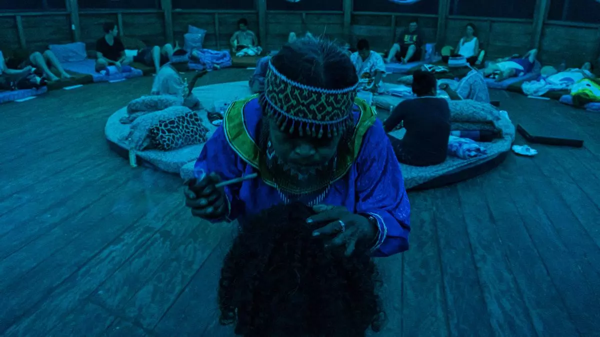 Before each ceremony, Justina Cerrano blows tobacco smoke over each of the participants to give them protection.