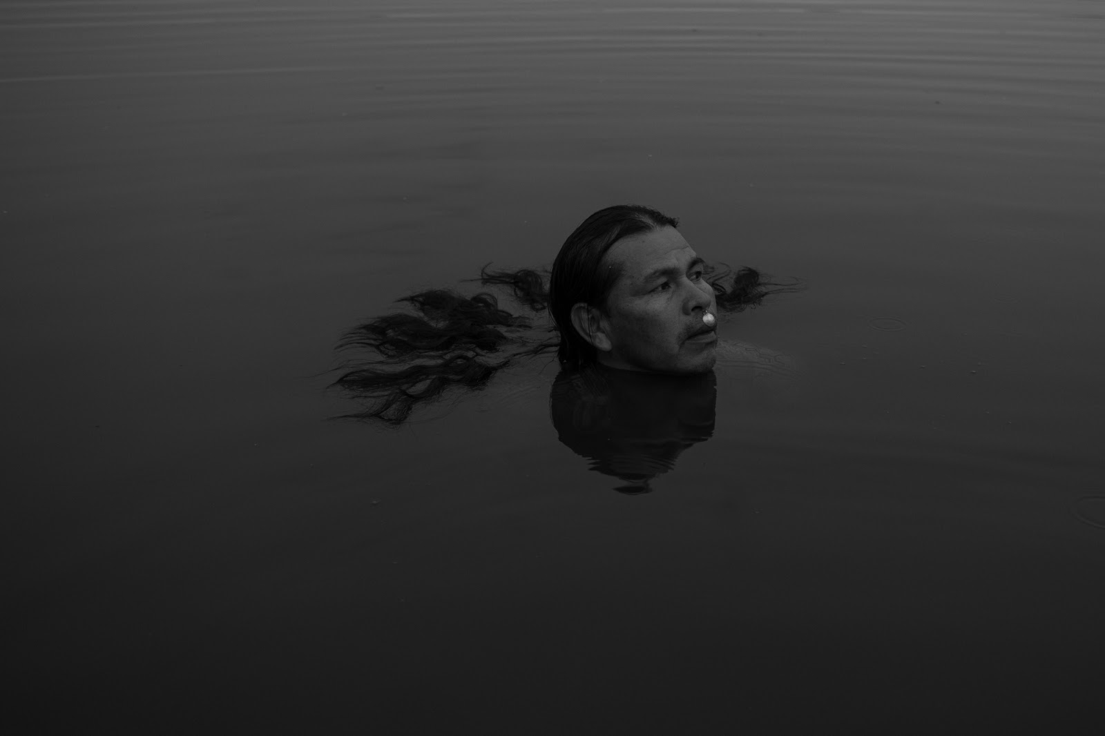 A man swimming with his head above the water.