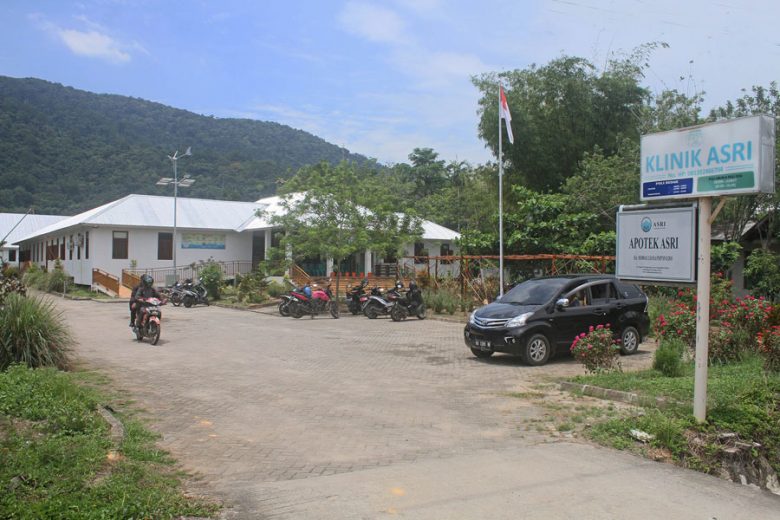rural medical clinic with a car and several motorcycles outside