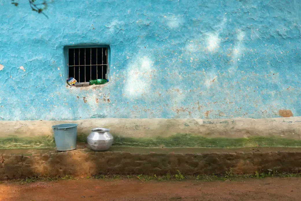 Water utensils are kept outside of a house in the Bastar district in central India. Image by Amitrane / Shutterstock. India, 2016.