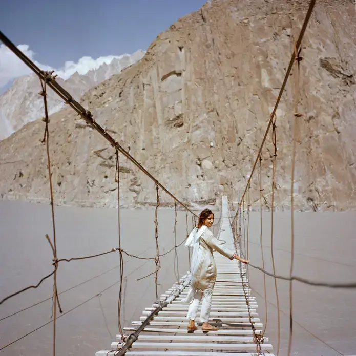British visitor Subeera Hussain walks along a hanging bridge near Passu, a town in the Hunza valley of northern Pakistan. She wishes more people knew about the country’s beauty. “Tell people about Pakistan, the real Pakistan” she says. “I’m traveling alone as a woman and I’ve never felt more safe.” Image by Sara Hylton/National Geographic. Pakistan, 2019.