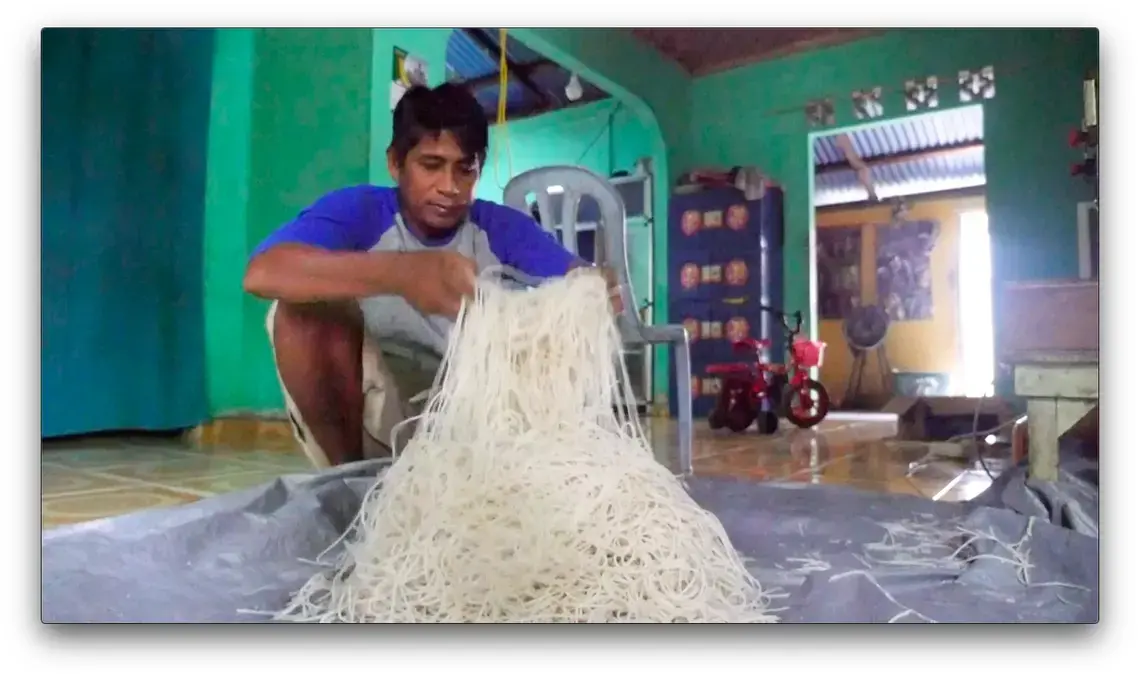 Sumatra farmer Abdul Manan makes pasta from the pith of sago palm trees. Unlike oil palm, which can only grown on dry land, the indigenous sago is water-tolerant. Indonesia wants farmers to plant more swamp trees, avoiding the need to drain its coastal wetlands. Image by Daniel Grossman. Indonesia, 2019.