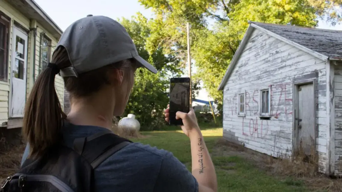 Kayla Vondracek photographs a structure preparing to be relocated. Image by University of Nebraska Lincoln. United States, 2020.
