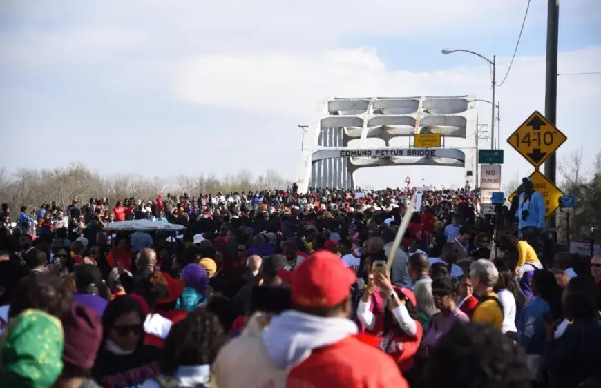 Marchers commemorating the ‘Bloody Sunday’ events of 1965 approach the Edmund Pettus Bridge, in Selma, Alabama, this past Sunday. Image by Brittany Gibson. United States, 2020.
