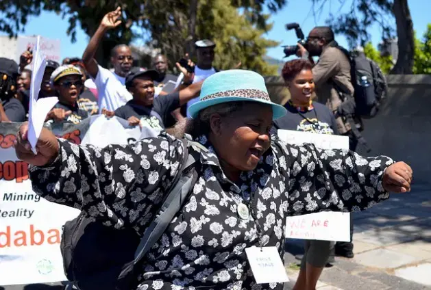 A delegate of the Alternative Mining Indaba dances during a protest march in Cape Town, South Africa, in February. Image by Mark Olalde. South Africa, 2017.