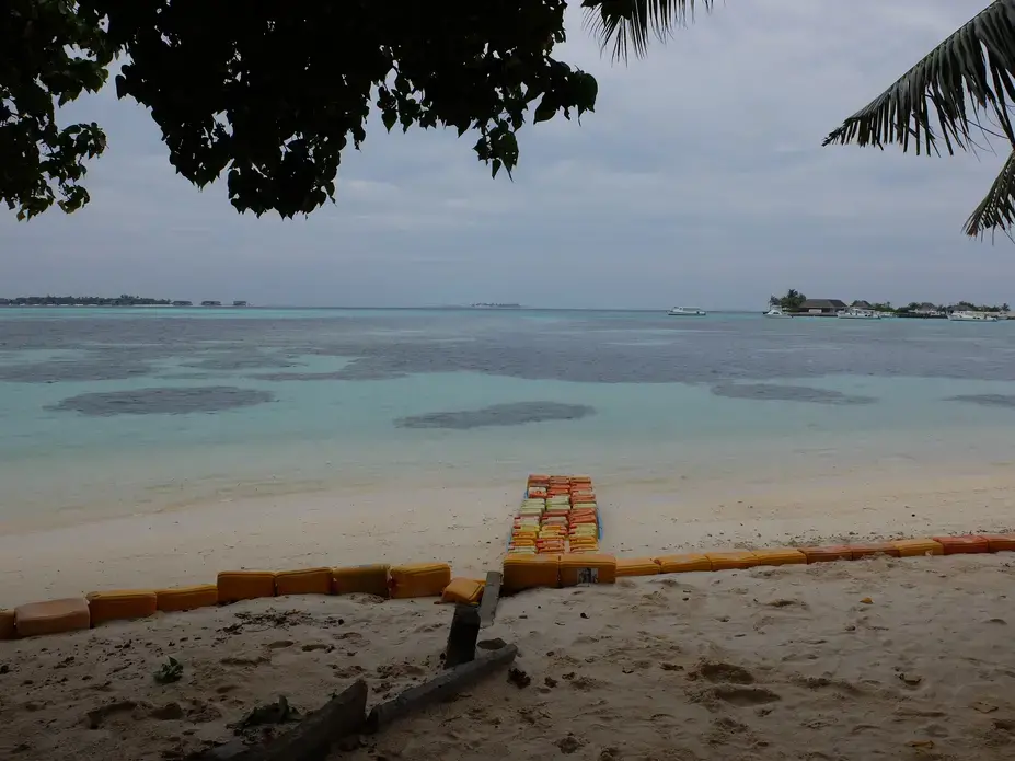 Plastic jerrycans have been staked on the beach of Guraidhoo, Maldives, to protect the shoreline during storm surges. Image by Kai Schultz. Maldives, 2017.