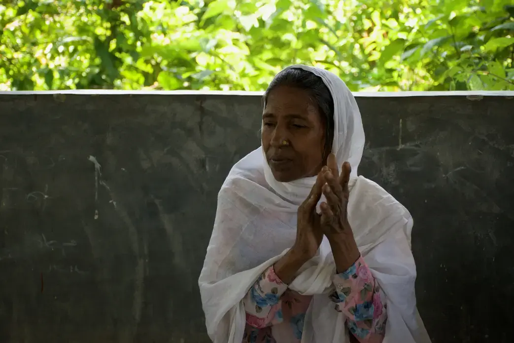 Mustava, 59, sings and plays the harmonium with a band in a Rohingya refugee camp in Bangladesh. “There are people who do not like music, especially when women do it,” she says. “But people like us, we value music because it refreshes our soul.” Image by Sasha Ingber. Bangladesh, 2018.