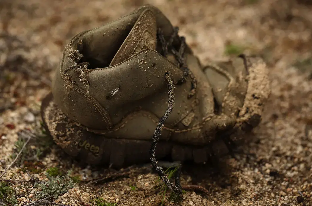 Personal items are left in the desert near the United States-Mexico border wall in Tecate, Mexico. This area is known to be a location for smugglers to bring people into the U.S. Image by Erika Schultz. Mexico, 2019.