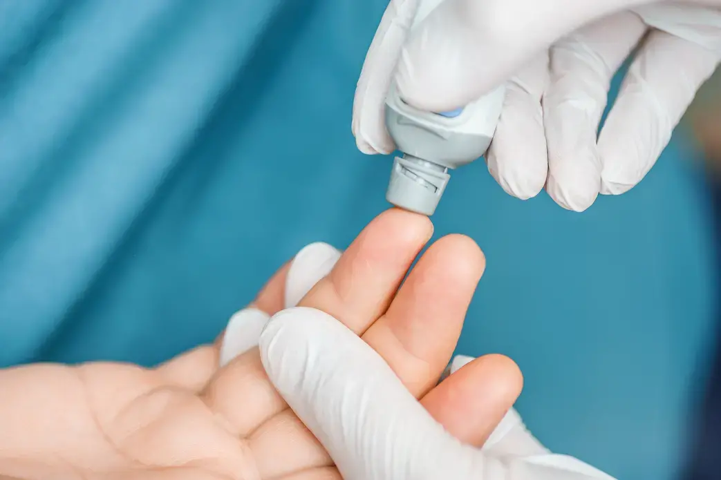 A doctor tests a patient's blood at the hospital. Image via Shutterstock.