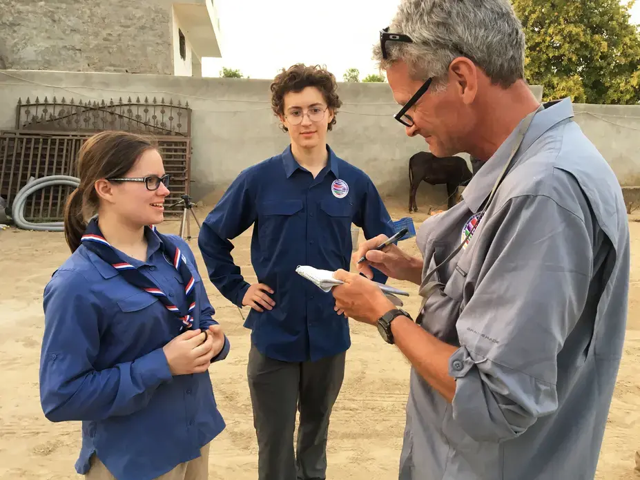Scouts Miciah Thacker and Chris Sherman learn interviewing techniques from National Geographic Fellow Paul Salopek during a visit in northern India. Image by Mark Schulte. India, 2018.