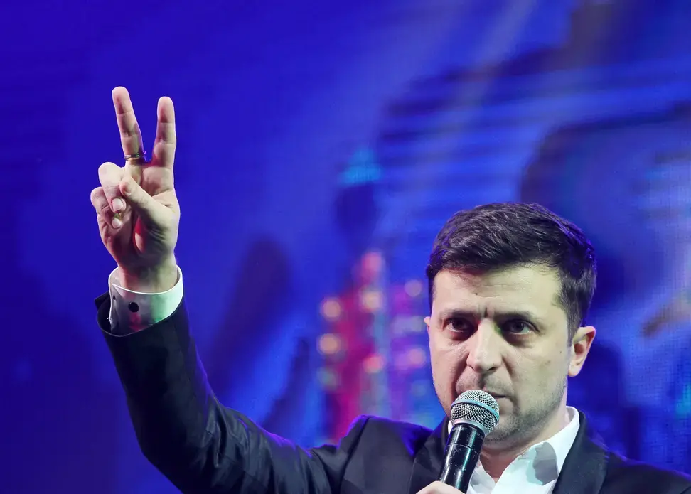 Ukrainian President-elect Volodymyr Zelenskiy shows victory sign during a comedy show at a concert hall in Brovary. Ukraine, 2019. Image by Shutterstock.