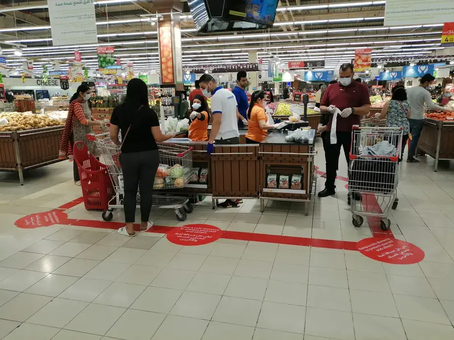 A supermarket stipulates social distancing for customers during the novel coronavirus pandemic outbreak. Image by Arnold O. A. Pinto / Shutterstock.com. United Arab Emirates, 2020.