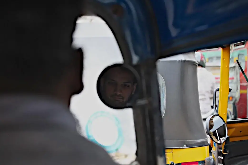 Priyank Mathur, creator of the "Fight Terror With Comedy" programs rides in a rickshaw through Mumbai. Image by Wes Bruer. India, 2017.