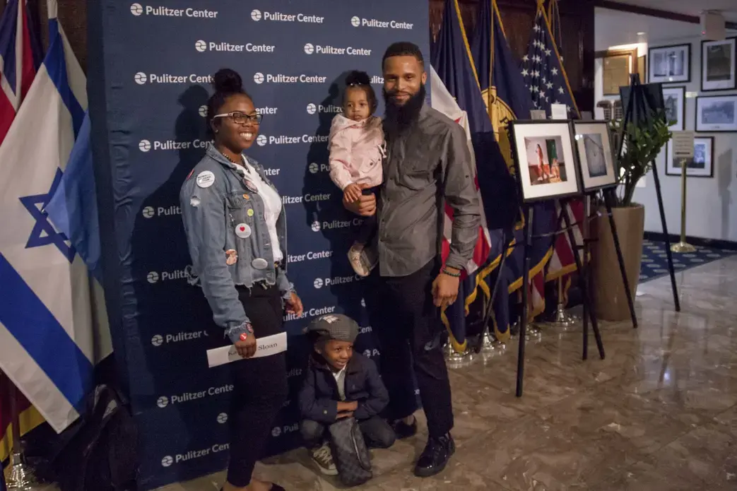 Young activist Kamryn Sloan stands with her brother, Armani Sloan, and his children. Image by Jin Ding. Washington, DC, 2018.