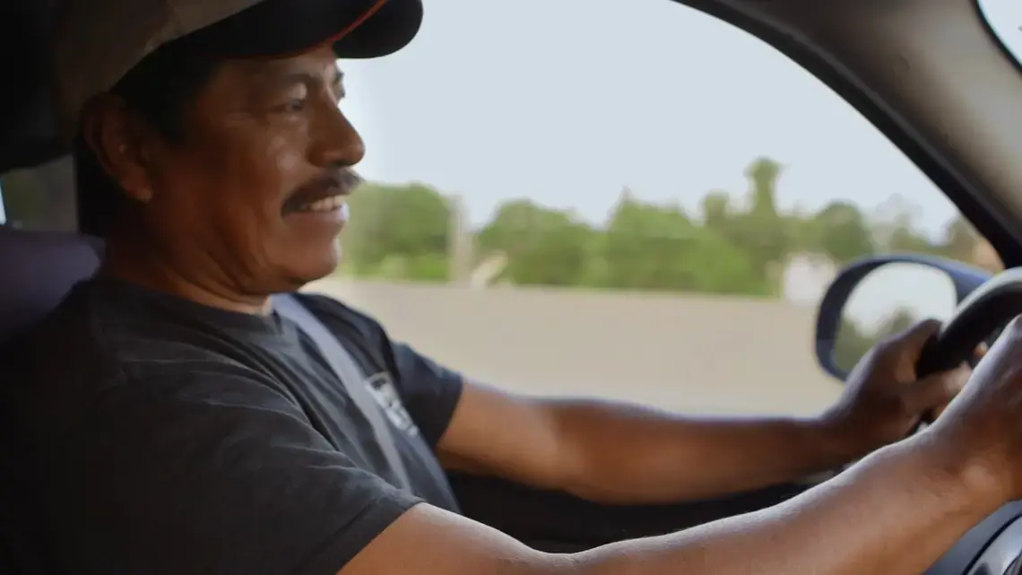 Winny Contreras drives to the farm he lives and works on while reminiscing about his son's message on Father's day. Image by Sana Malik. United States, 2019.