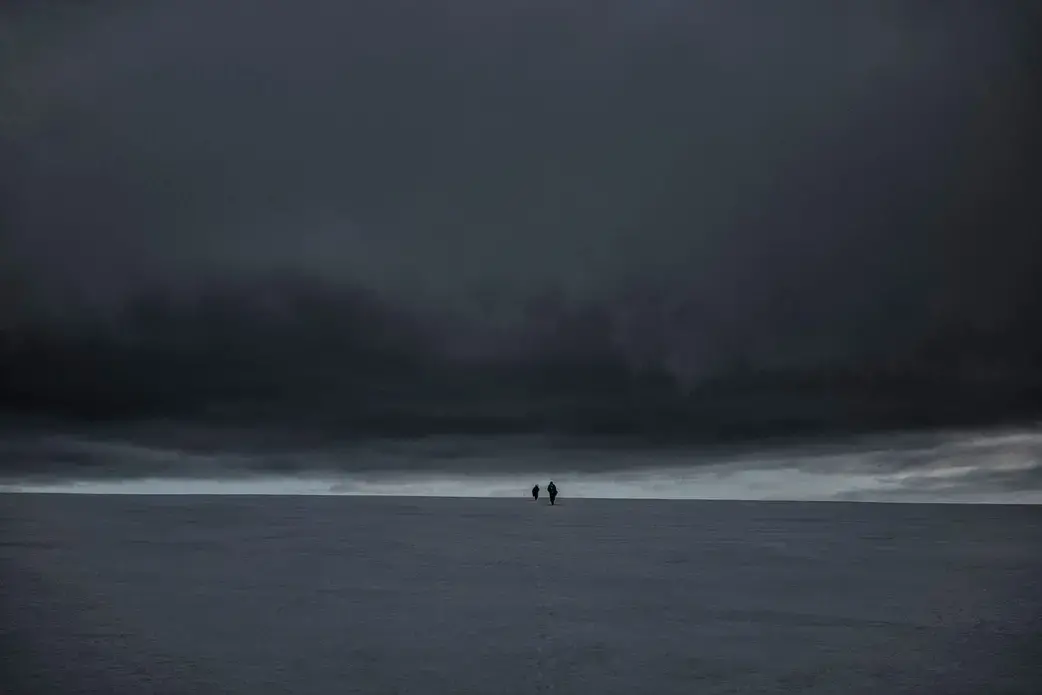 Glaciologists climb the Bellingshausen Dome to measure the depth and consistency of this 500-foot-deep cap of ancient ice in Antarctica. Image by James Whitlow Delano. Antarctica, undated.