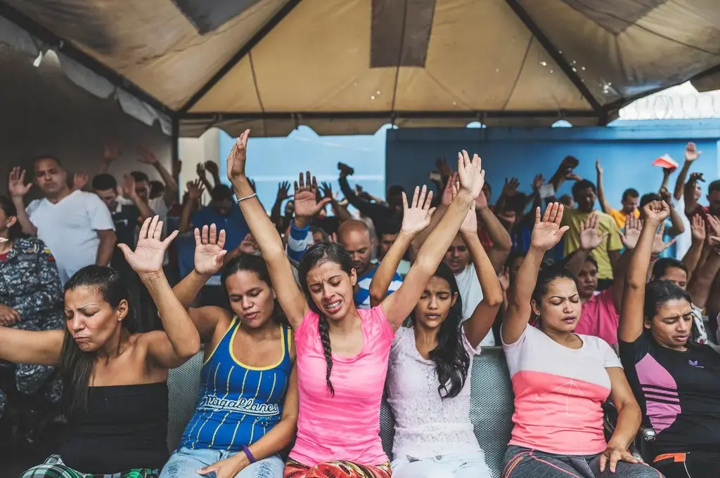 Male and female detainees attend an evangelical service at La Yaguara Detention Center, Caracas, where a preacher discussed forgiveness and reflection, followed by a religious play and a shared meal. Image by Ana María Arévalo. Venezuela, 2018.
