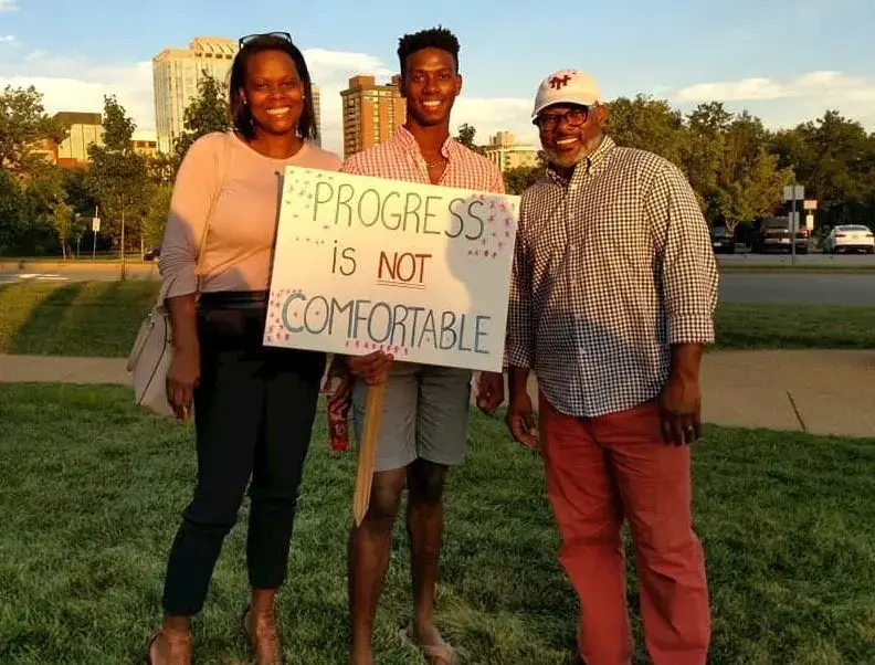 The Washingtons, Theo, Denise and their son, Teddy at a rally supporting racial equity in Clayton, Mo. Courtesy of the Washington family. United States, 2019.