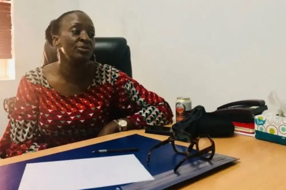 Joyce Okungbowa, founder of the Domestic Violence Assistance Line Initiative, sits at her desk in her office. Image by Joy Ikekhua. Nigeria, 2019.