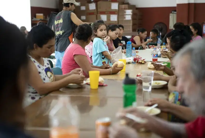 A young girl stands on a chair in the dining hall at Casa Indi in Monterrey, Nuevo Leon on Aug. 5, 2019. The Mexican government has been busing migrants away from the border and into the interior of the country. Image by Miguel Gutierrez Jr. Mexico, 2019.