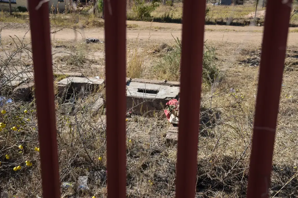 A ground pit latrine that has been gated off due to the immediate danger it posed to students at the Utjane Primary School in Limpopo. Image by Adam Yates. South Africa, 2018.