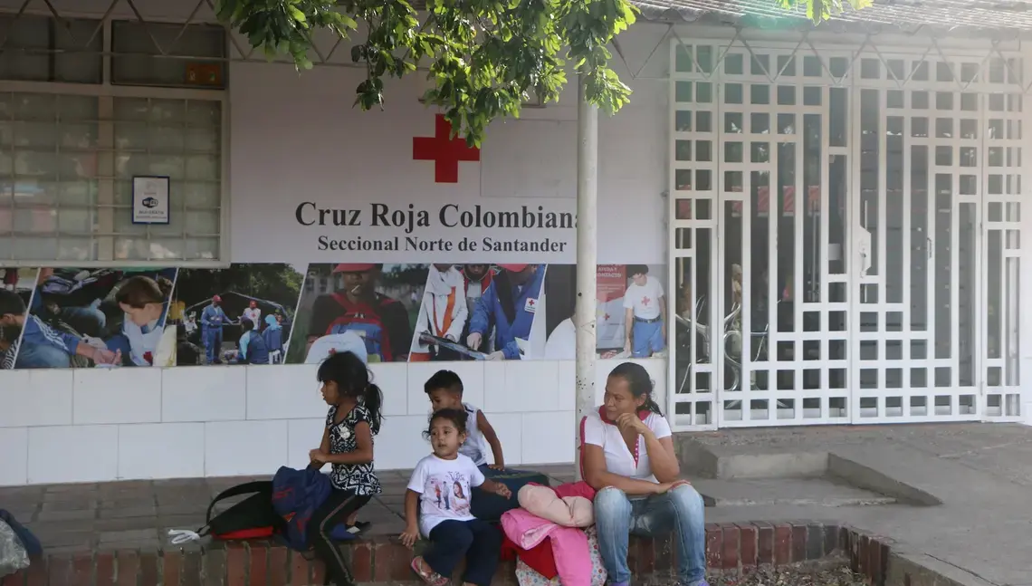 A Venezuelan family waits outside a Red Cross center in Norte de Santander. Image by Patrick Ammerman. Colombia, 2019.
