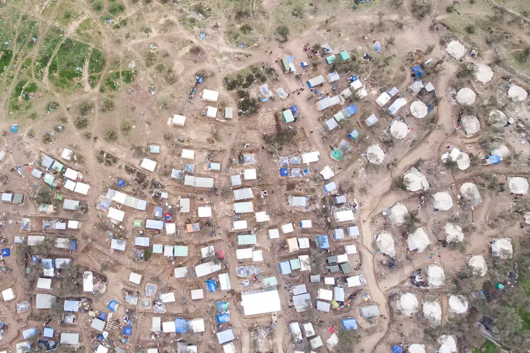 Aerial view of Moria Refugee camp and makeshift settlement around it. Image by Nicolas Economou / Shutterstock. Greece, 2020.