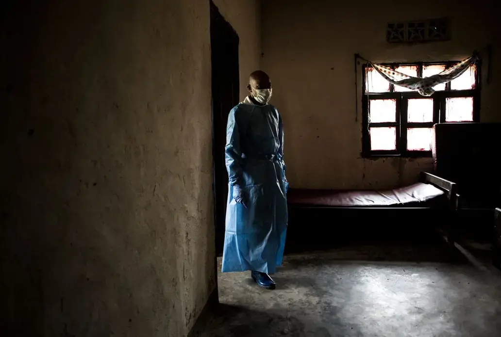 Health workers in a war-weary region are confronted with Ebola, a deadly virus that has claimed more than 2,000 lives. Image by John Wessels. Democratic Republic of Congo, 2019.