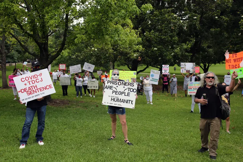 Family members of prisoners held in Texas' state prison system demonstrate at the Governor's Mansion in Austin for their release on parole due to the danger of COVID-19 in prisons. Image by Vic Hinterlang / Shutterstock. United States, 2020.