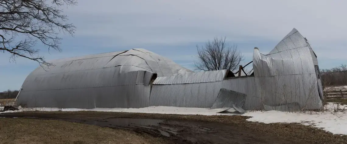 Bruce Drinkman's collapsed machine shed at his farm in Ridgeland. Image by Mark Hoffman. United States, 2019.