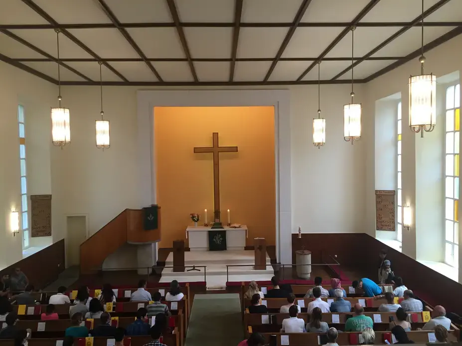 Visiting Trinity Church in Berlin one Sunday in July 2016. Half of the service was translated into Farsi. Image by Laura Kasinof. Germany, 2016.