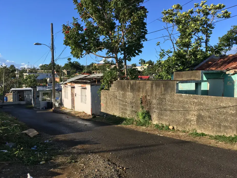 A row of houses in Guayama, destroyed and unfixed six months after Hurricane Maria. Image by Isabel S. Dieppa. Puerto Rico, 2017.