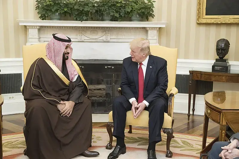 President Donald Trump speaks with Mohammed bin Salman bin Abdulaziz Al Saud, Deputy Crown Prince of Saudi Arabia, during their meeting Tuesday, March 14, 2017, in the Oval Office of the White House in Washington, D.C. Image by Shealah Craighead. US, 2017.