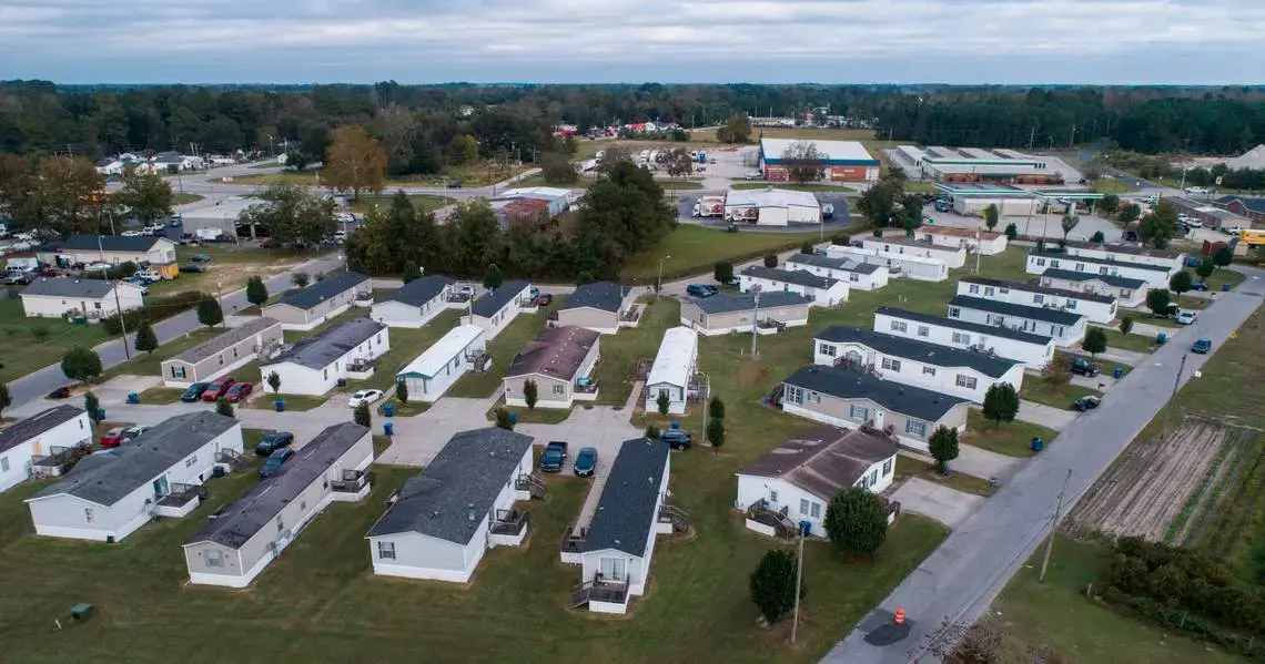 Abbott Park, a mobile home park in Lumberton, N.C., pictured here on Friday, Oct. 16, 2020, is owned by Time Out Communities. According to an Associated Press report, the company bought almost all of the mobile home parks in Lumberton after Hurricane Florence. Researchers examining the health effects of rising temperatures in counties like Robeson, which is located in the Sandhills region of the state, are looking at how higher temperatures can impact residents of mobile home parks and exacerbate social…