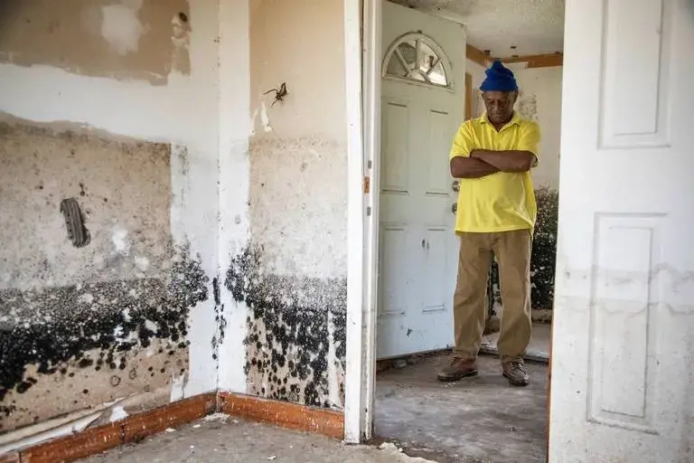 Sellers, South Carolina Mayor Barbara Hopkins shows homes damaged by repeated flooding and hurricanes on February 13, 2020. While many homeowners across the small town have received help from FEMA and other natural disaster response agencies, those without a clear title for their home have been left with no government help in mold saturated homes. Image by Joshua Boucher. United States, 2020.
