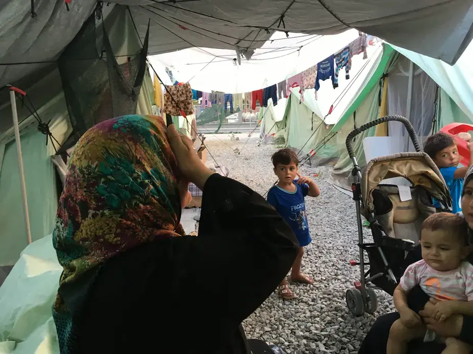 A woman and her children at Softex refugee camp in northern Greece. Image by Jeanne Carstensen. Greece, 2016.