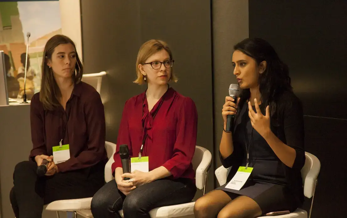 Student Fellow team, Thea Piltzecker and Liz Scherffius (Columbia University Graduate School of Journalism) listening to Divya Mishra (Johns Hopkins Bloomberg School of Public Health) during the Q&amp;A for The Refugee Experience Panel at 2018 Washington Weekend. Image by Jin Ding. United States, 2018.