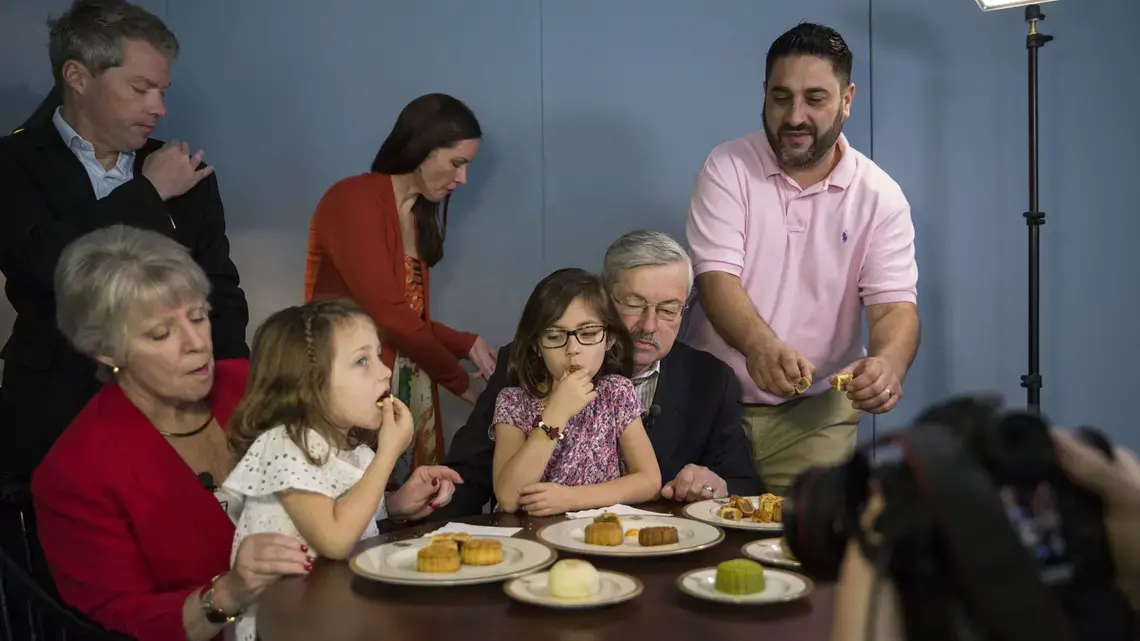 The Branstad family is filmed while eating mooncakes for a Mid-Autumn Festival video greeting filmed by members of the U.S. Embassy staff on Sunday, Sept. 24, 2017, at the ambassador's residence in Beijing, China. Mooncakes are traditionally eaten to celebrate the holiday, which fell on Oct. 4 this year. Image by Kelsey Kremer. China, 2017.